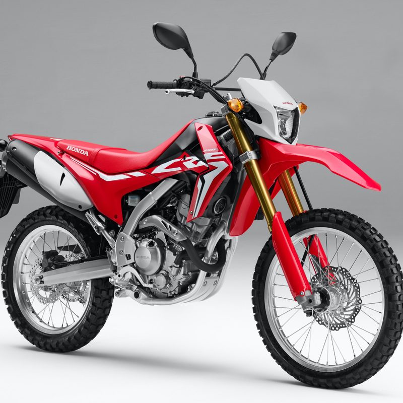 Front side profile of Honda CRF250L dirt bike motorcycle against a white backdrop
