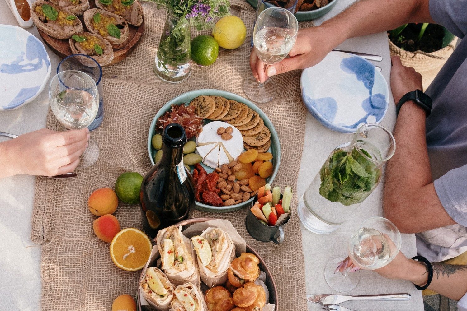 table with appetizers and people sitting around it