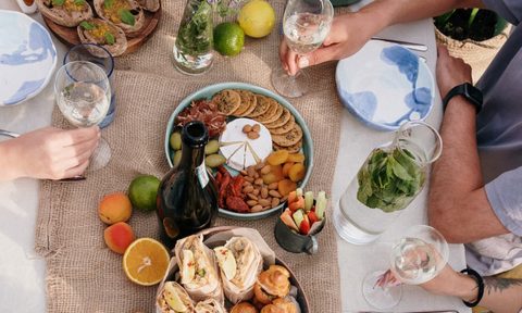 table with appetizers and people sitting around it