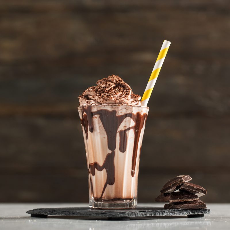 Chocolate milkshake and whipped cream on a table