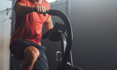 Endurance trainings: anonymous fit man working out on an exercise bicycle.