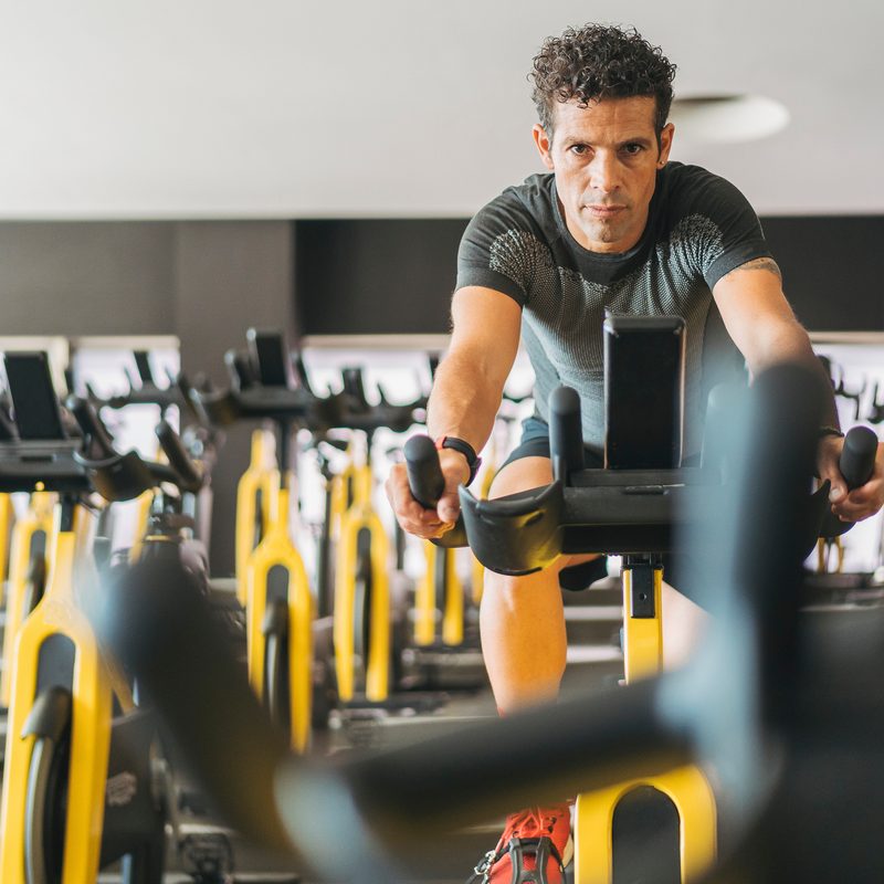 Man riding exercise bike.