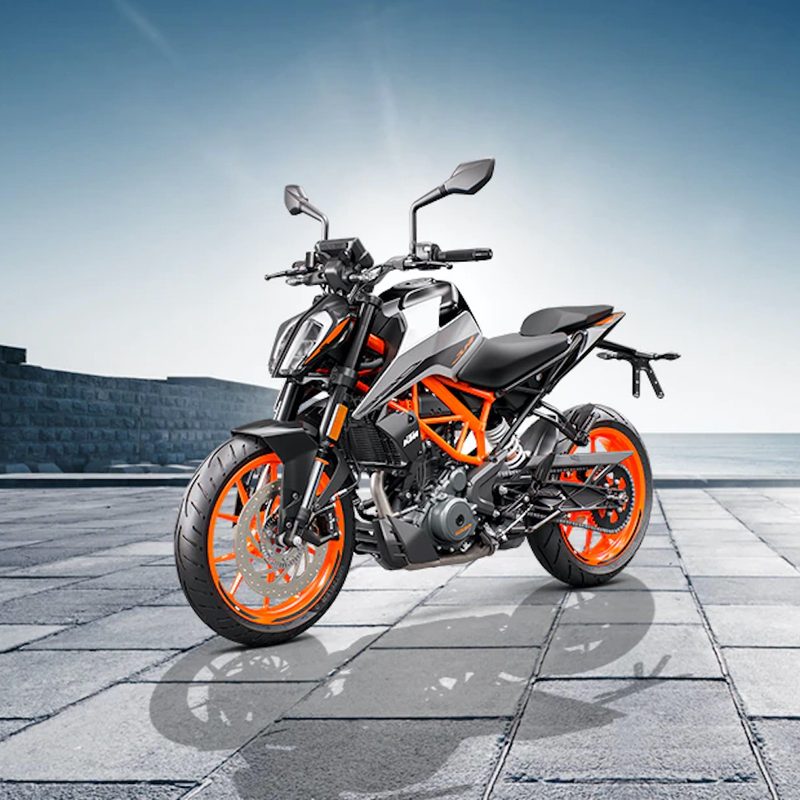 Front side profile of KTM 390 Duke on a brick road with a brick wall in the background
