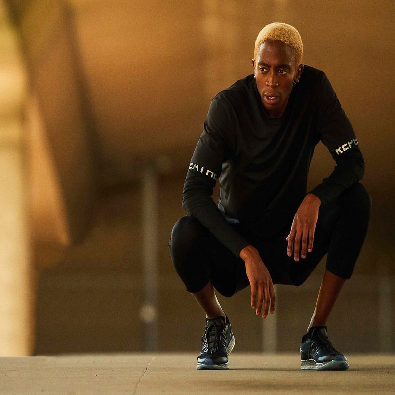 A man squatting after a seemingly tiring run in Lululemon gear