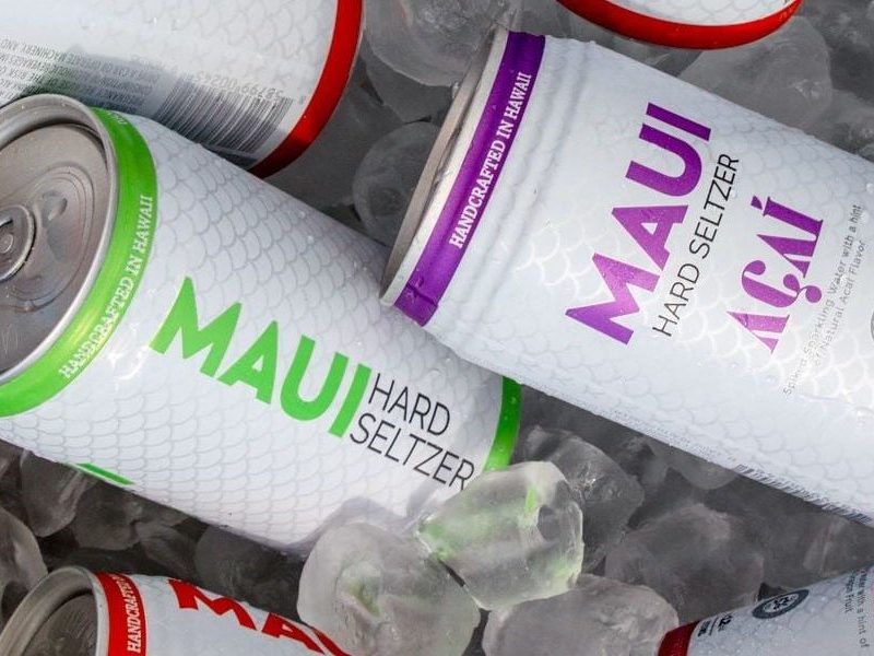 Cans of Maui Hard Seltzer with ice underneath.