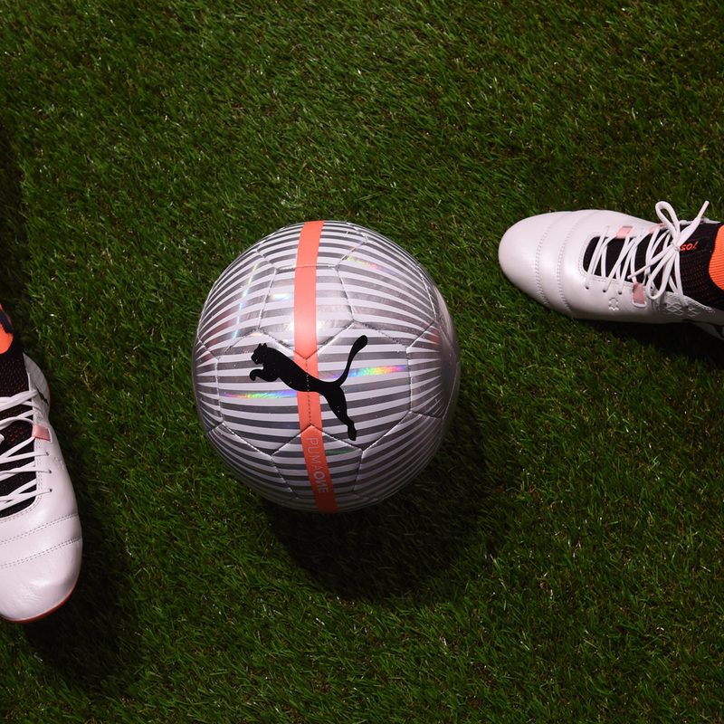 Two legs and a Puma soccer ball