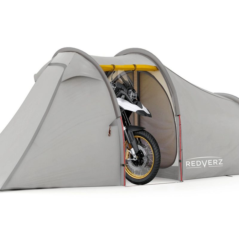 Adventure bike parked inside a Redverz Atacama Expedition Motorcycle Tent, isolated on a white studio background.