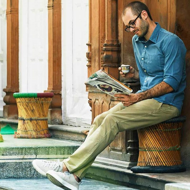 Man reading a paper outside his vacation rental