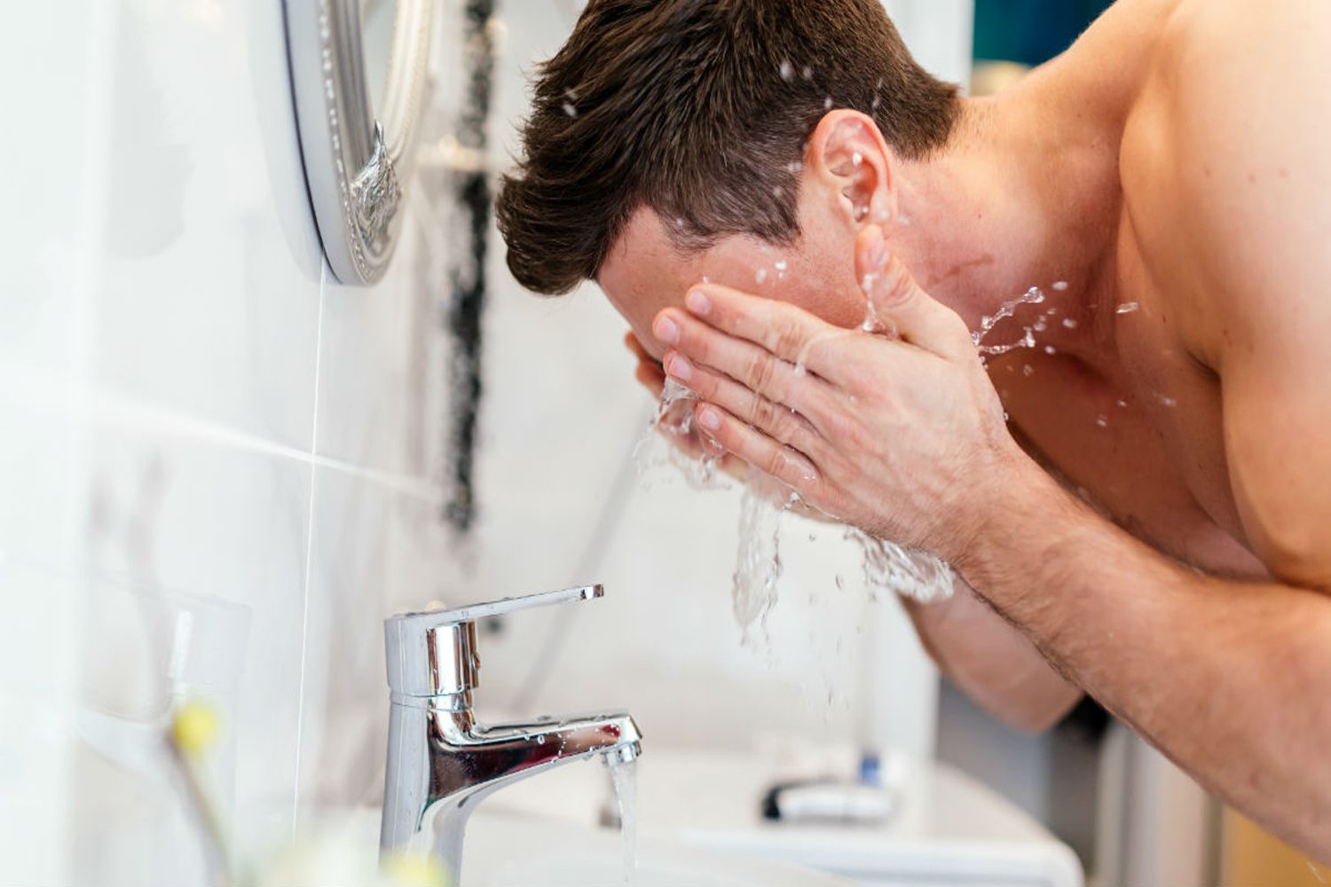 Man washing his face