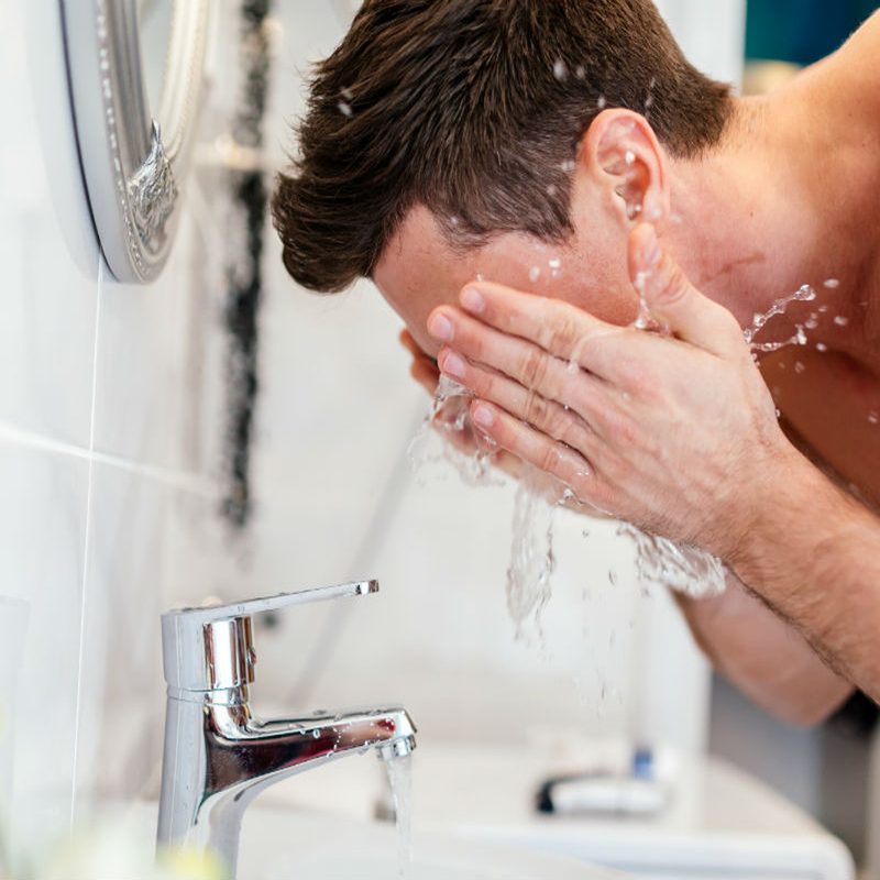 Man washing his face