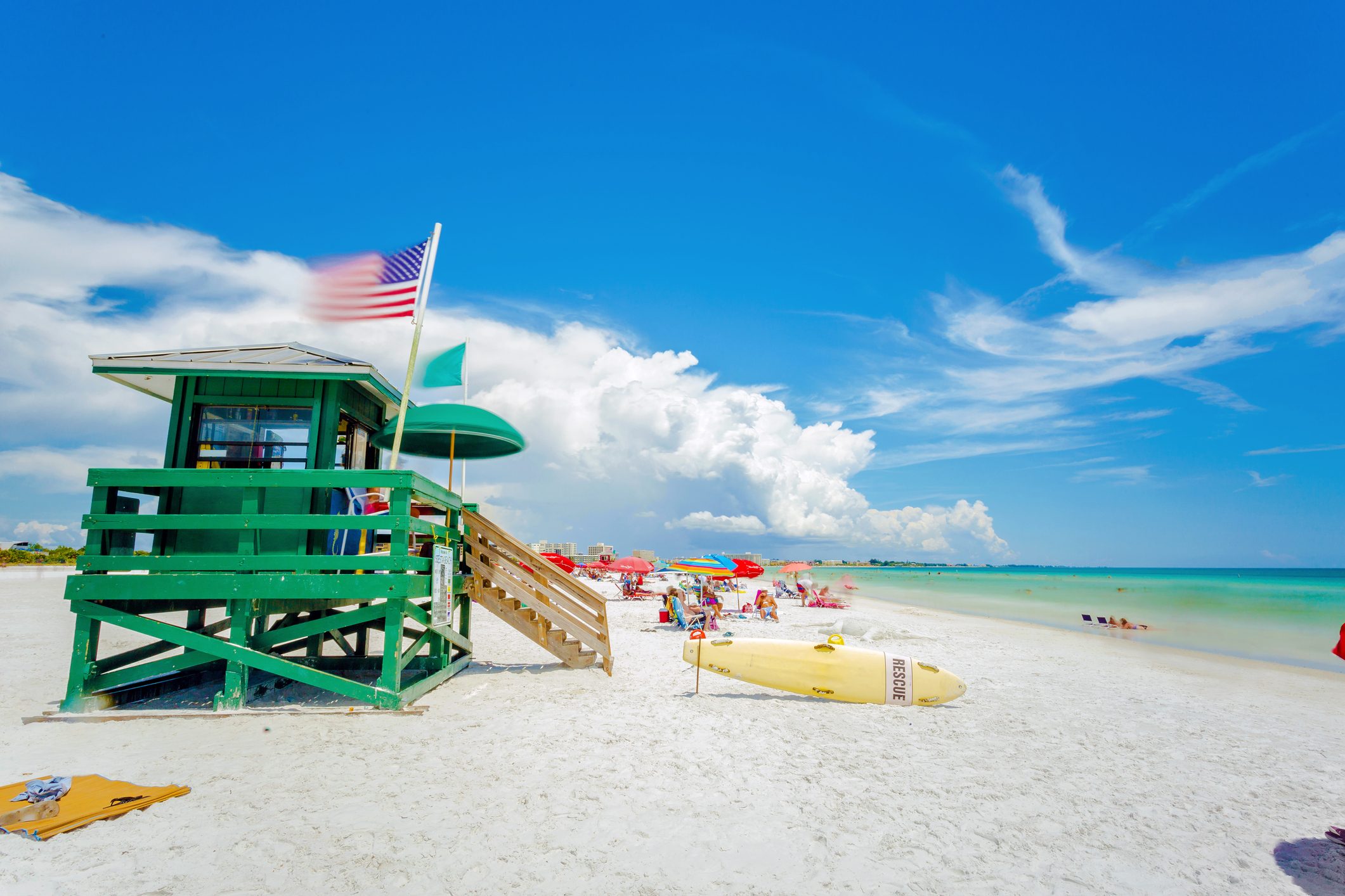 A lifeguard tower at Siesta Key beach in Sarasota, Florida with an American flag in the wind