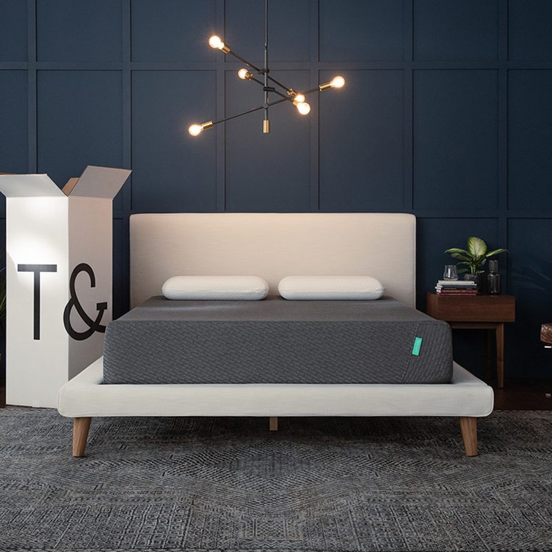 Tuft & Needle mattress in a box on a white bed frame.