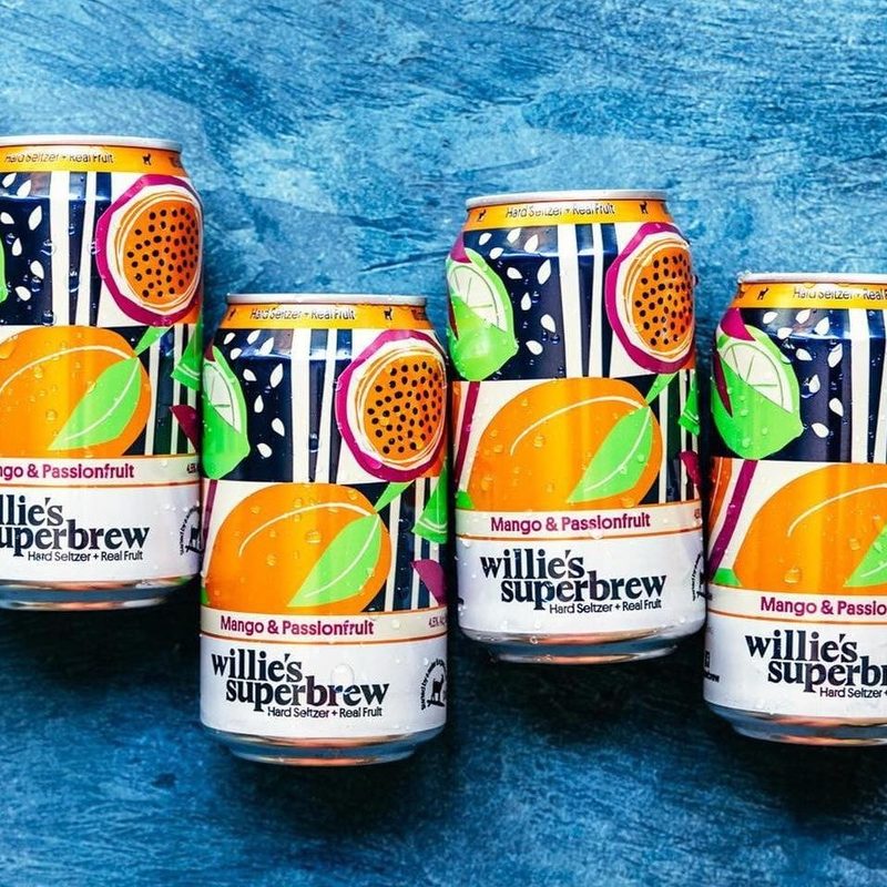 6 cans of Willie’s Superbrew messily lined up.