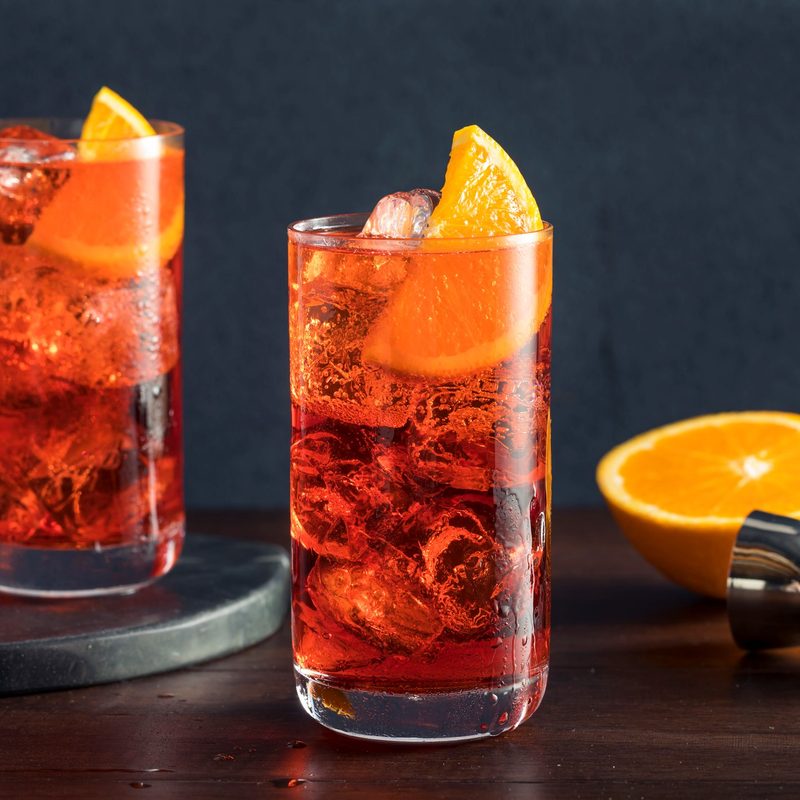 Refreshing vold Americano cocktail with an orange garnish