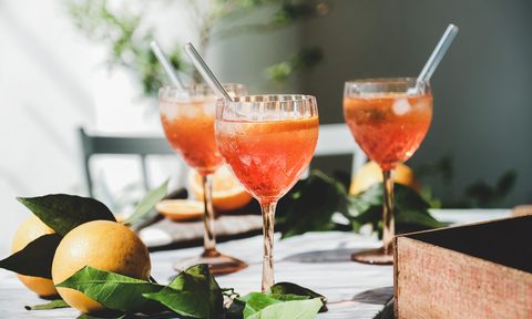 Aperol spritz cocktails in glasses with fresh oranges