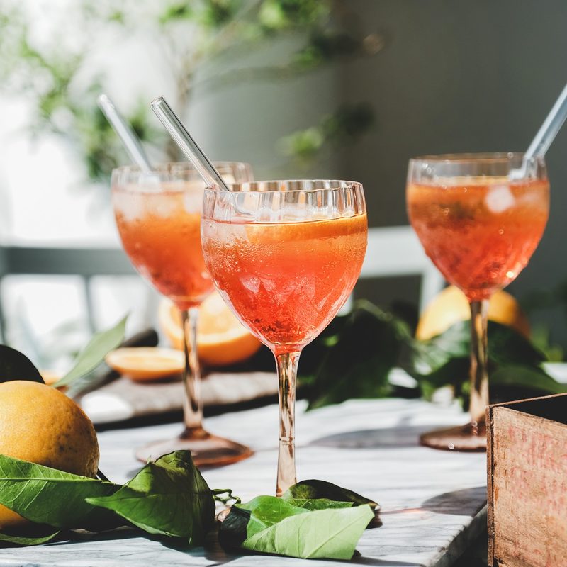 Aperol spritz cocktails in glasses with fresh oranges