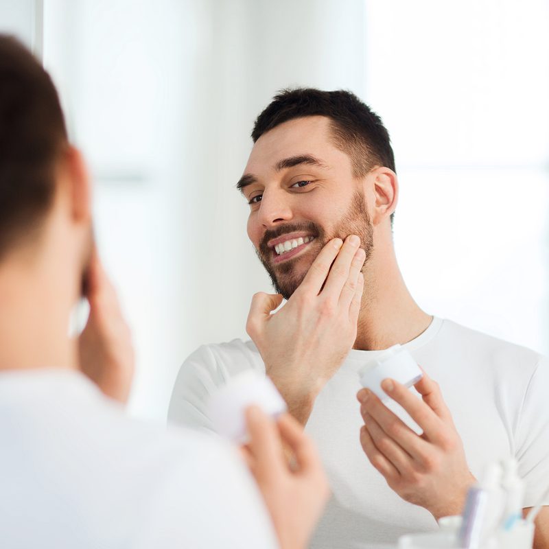 Man applying beard growth oil