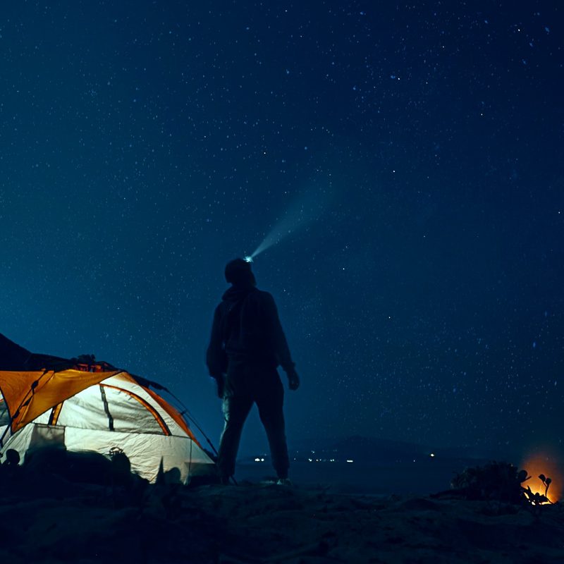 Man at a campground stargazing