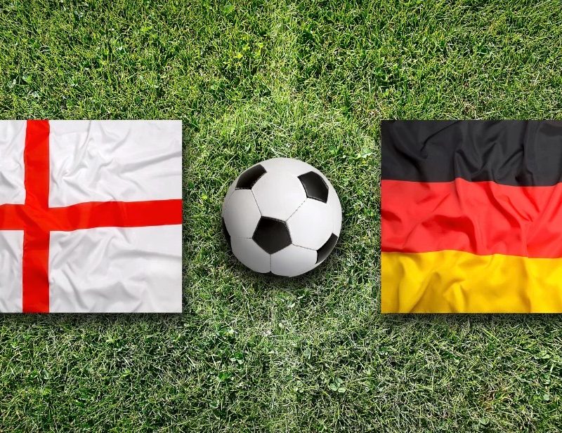 The English and German flags on a soccer pitch with an soccer ball between them.