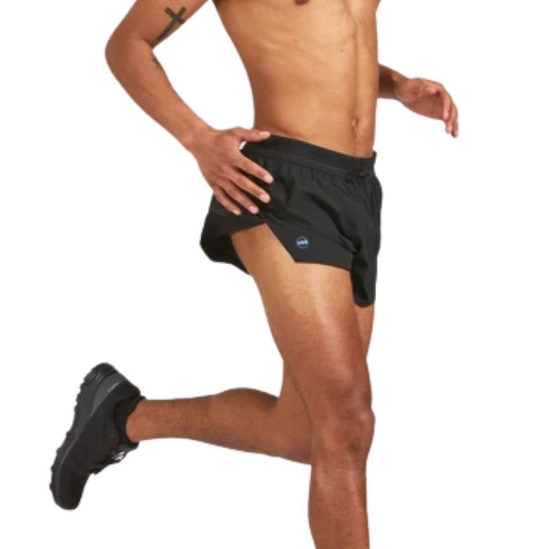 A running man wearing a black Janji Short.