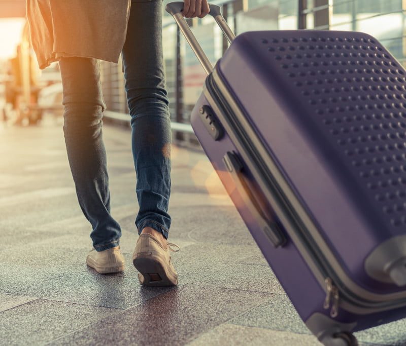 Man pulling luggage at an airport