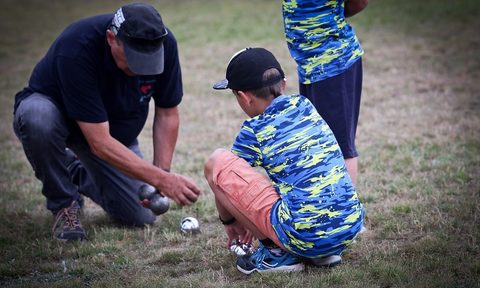 Man and kids with bocce balls