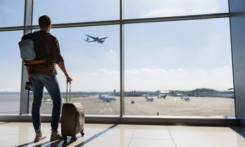 Man waiting for flight at airport.