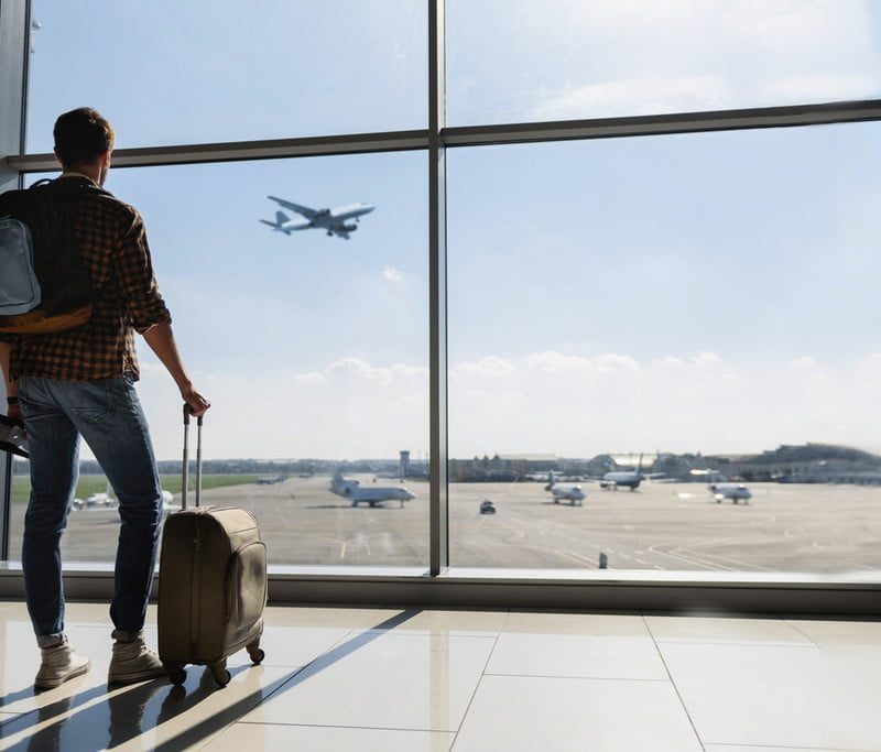 Man waiting for flight at airport.
