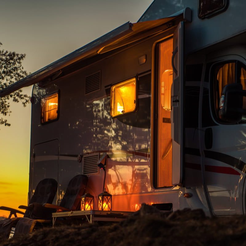 Scenic RV camping spot during sunset with a Class C motorhome camper
