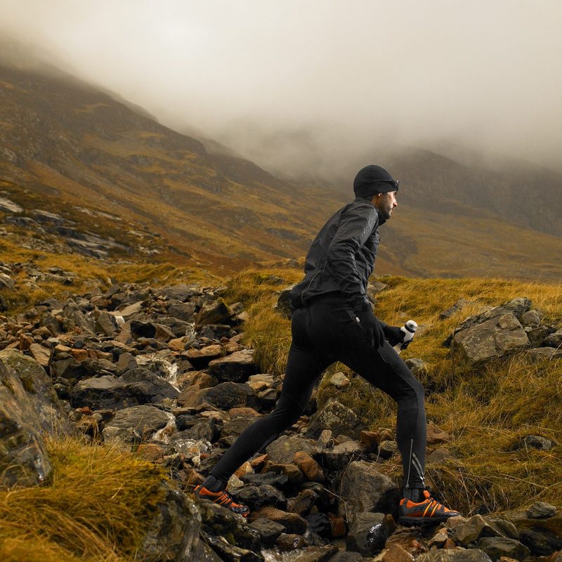 Man running across rocky terrain.