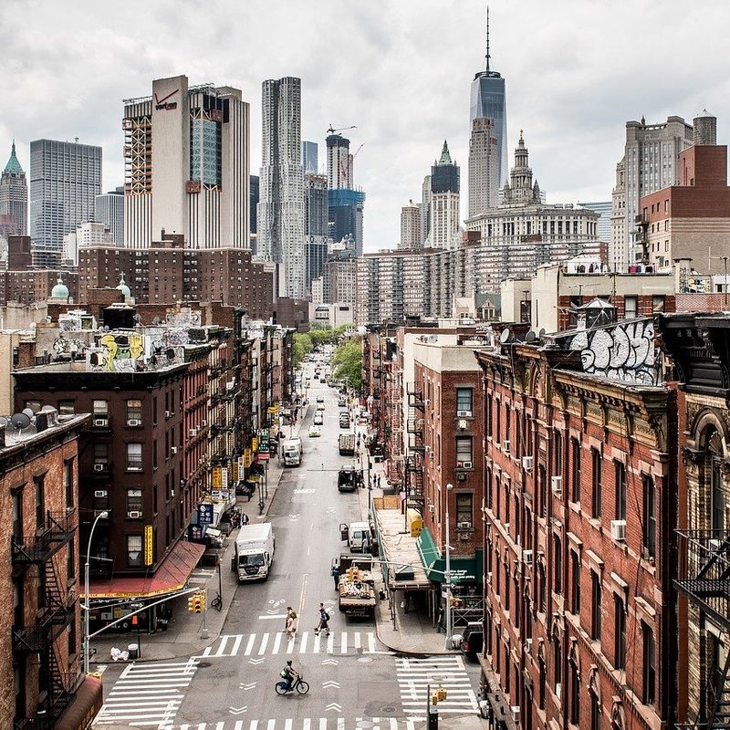 Looking down a street in New York City with skyscrapers in the distance. 