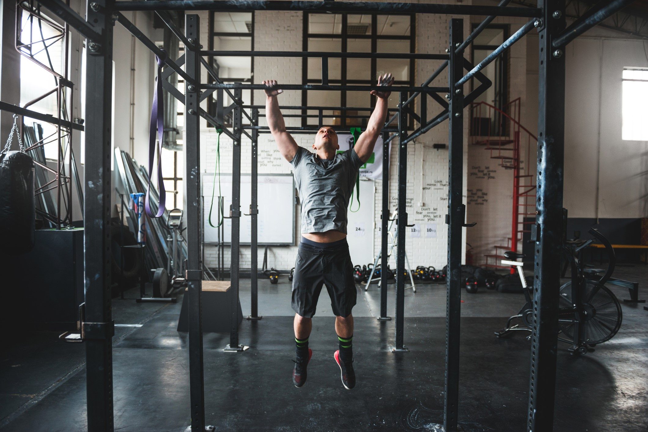 Man doing pull-ups in a gym