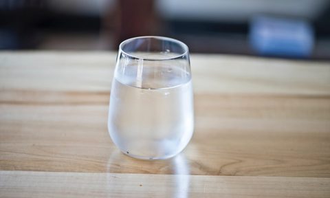 Glass of water on table.