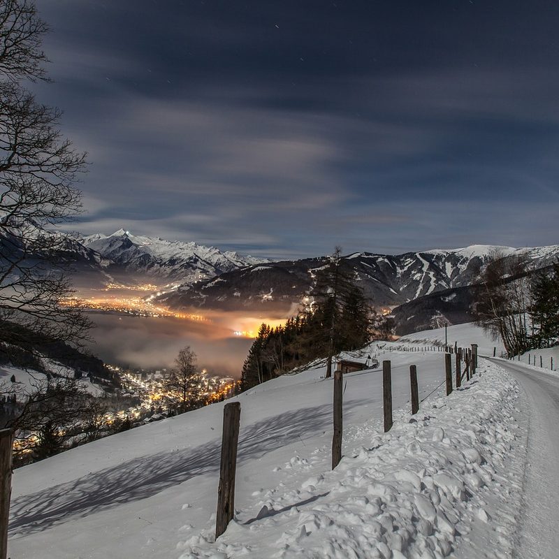 night skiing over a town at night