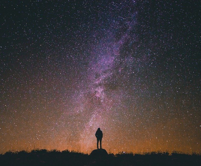 person standing under night sky