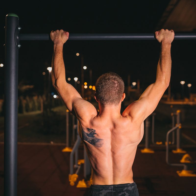 Muscular man doing his workout outdoors