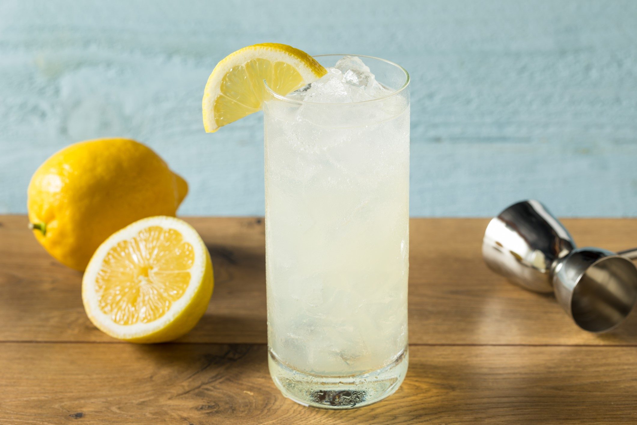 Refreshing gin Tom Collins cocktail with lemon