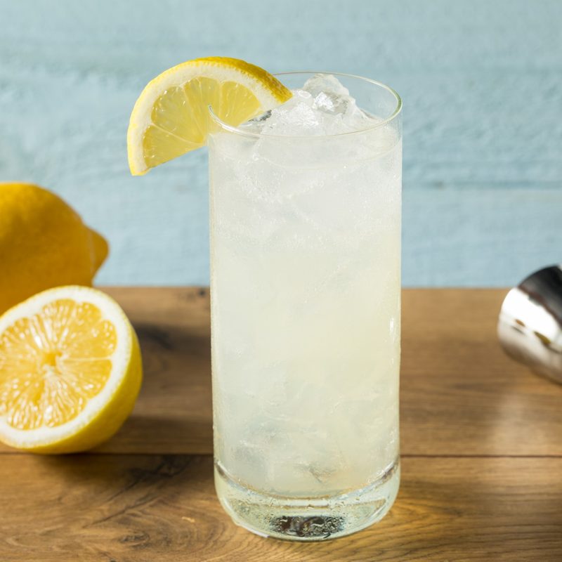 Refreshing gin Tom Collins cocktail with lemon