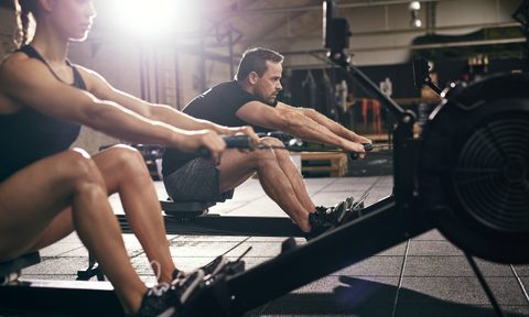 Two people on rowing machines.