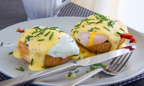 Eggs Benedict. toasted muffins, ham, poached eggs, and delicious buttery hollandaise sauce