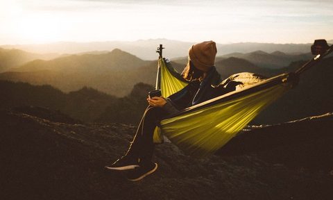 camping hammock tent woman in watching sunrise