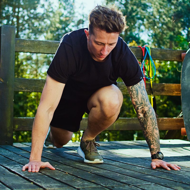 Garden workout. Man doing push ups on a patio