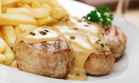 A plate of onion sauce on pork chops