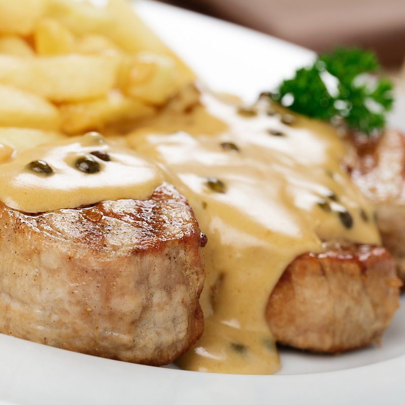 A plate of onion sauce on pork chops