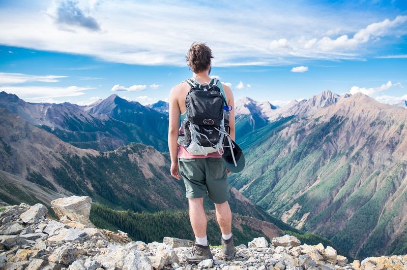 Man looking over a trail's vista