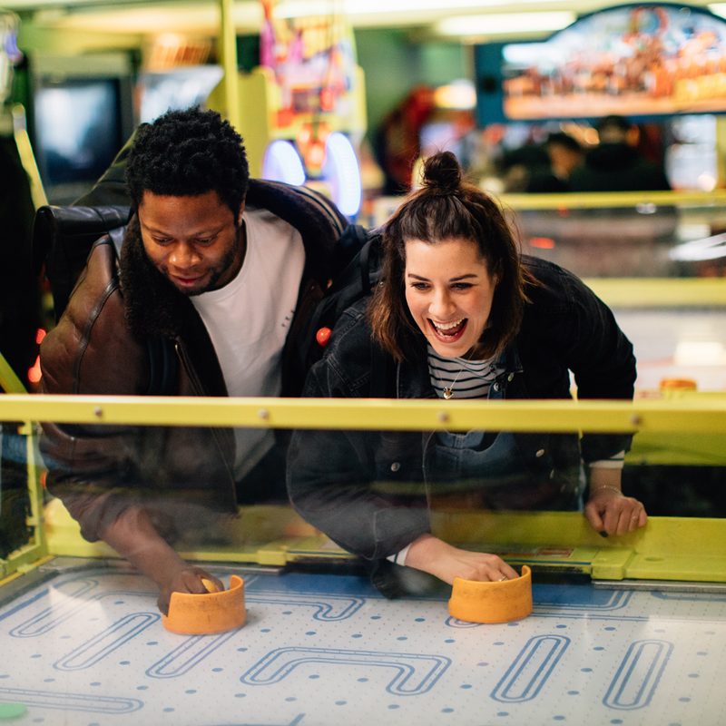 A couple enjoying an arcade game