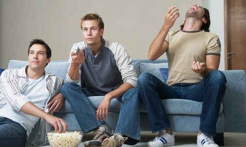 Men eating popcorn.