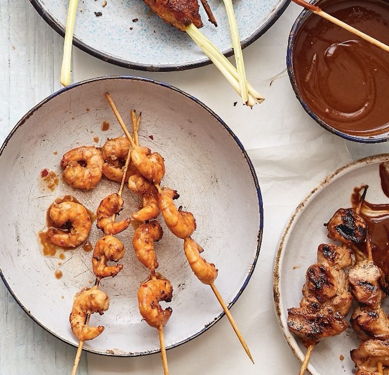 Indonesian Chicken Sate messily served and garnished with sauce.