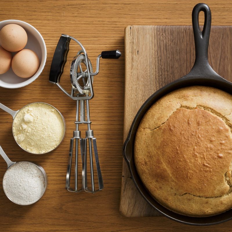 Cornbread in cast iron pan with ingredients.