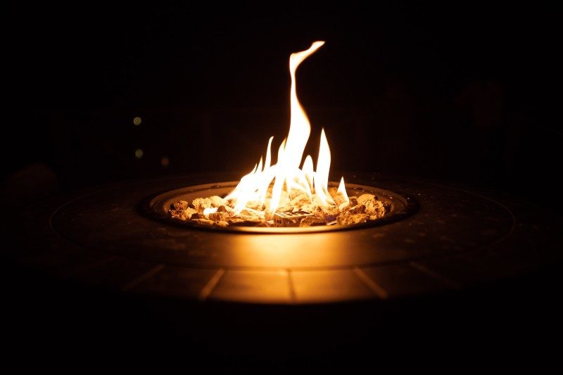Round gas fire pit at night